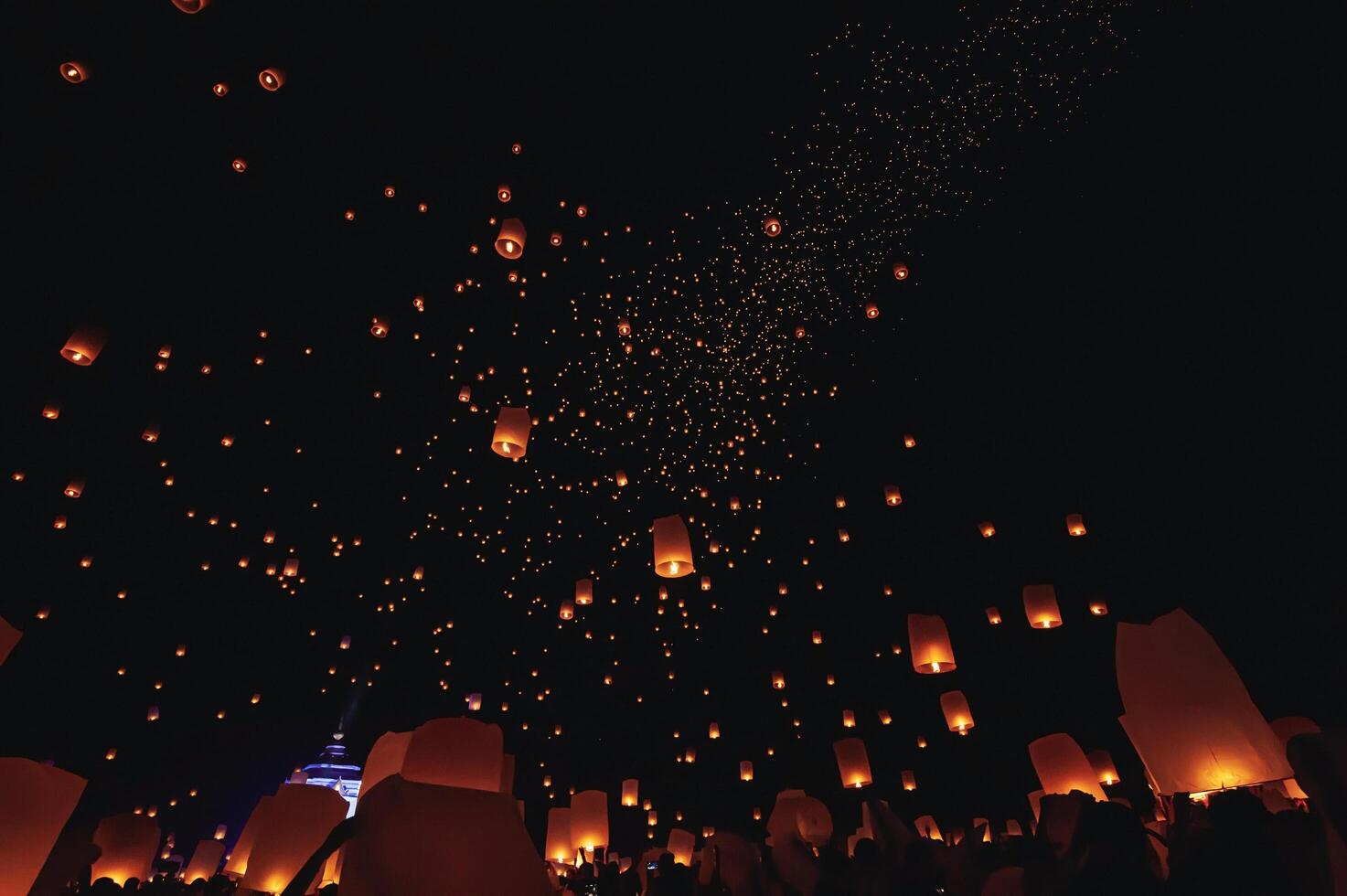 The beauty of the lanterns floating in the sky during the Yi Peng Festival and the Floating Lantern Festival in Chiang Mai Province, Thailand. photo