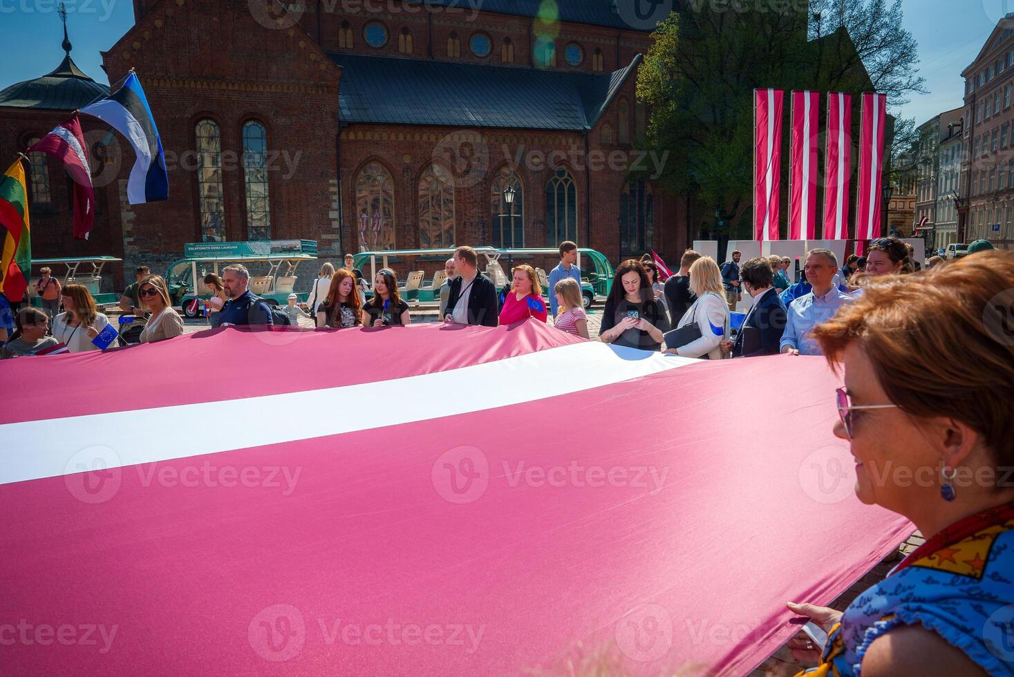 Vibrant Celebration in Riga's Old Town, Latvians Hold Flag photo