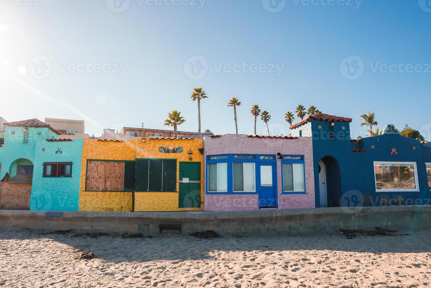 Colorful Beachfront Houses in Charming Tropical Locale with Palm Trees photo