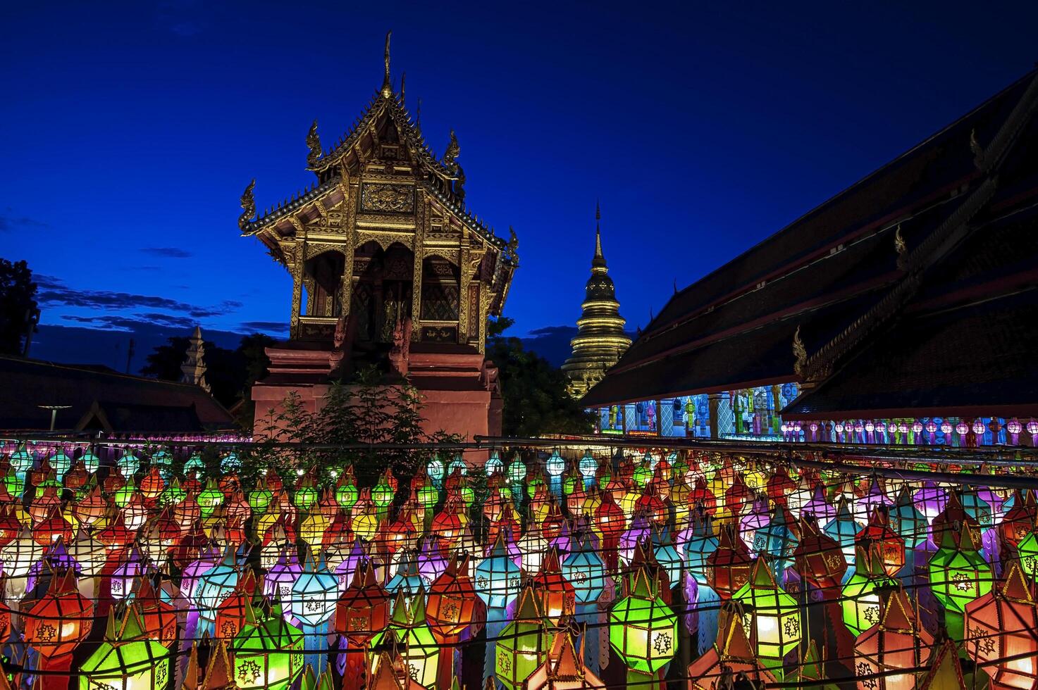 Lanterns made of colorful paper are hung during the annual festival at Wat Phra That Hariphunchai in Lamphun Province. photo