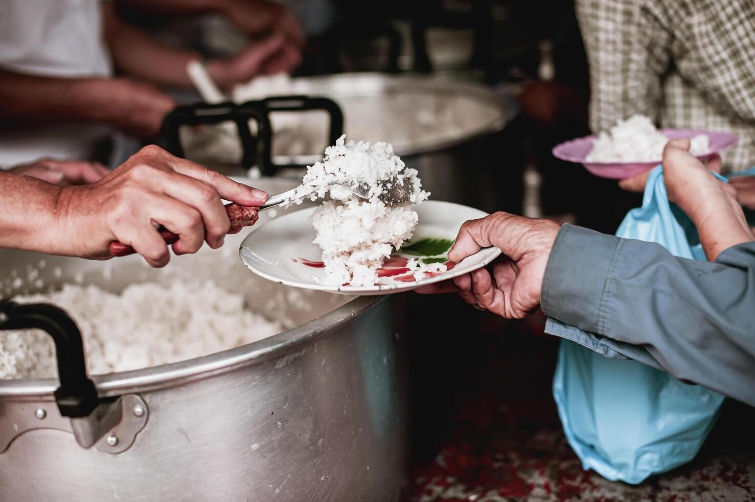 Feeding the poor to hands of a beggar. Poverty concept photo