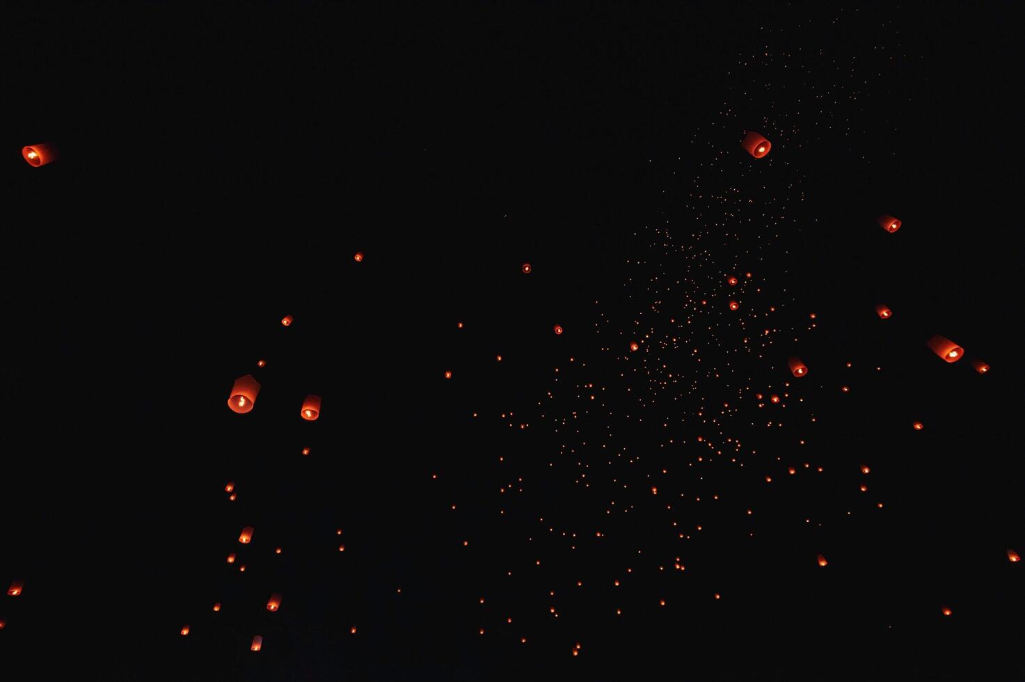 The beauty of the lanterns floating in the sky during the Yi Peng Festival and the Floating Lantern Festival in Chiang Mai Province, Thailand. photo