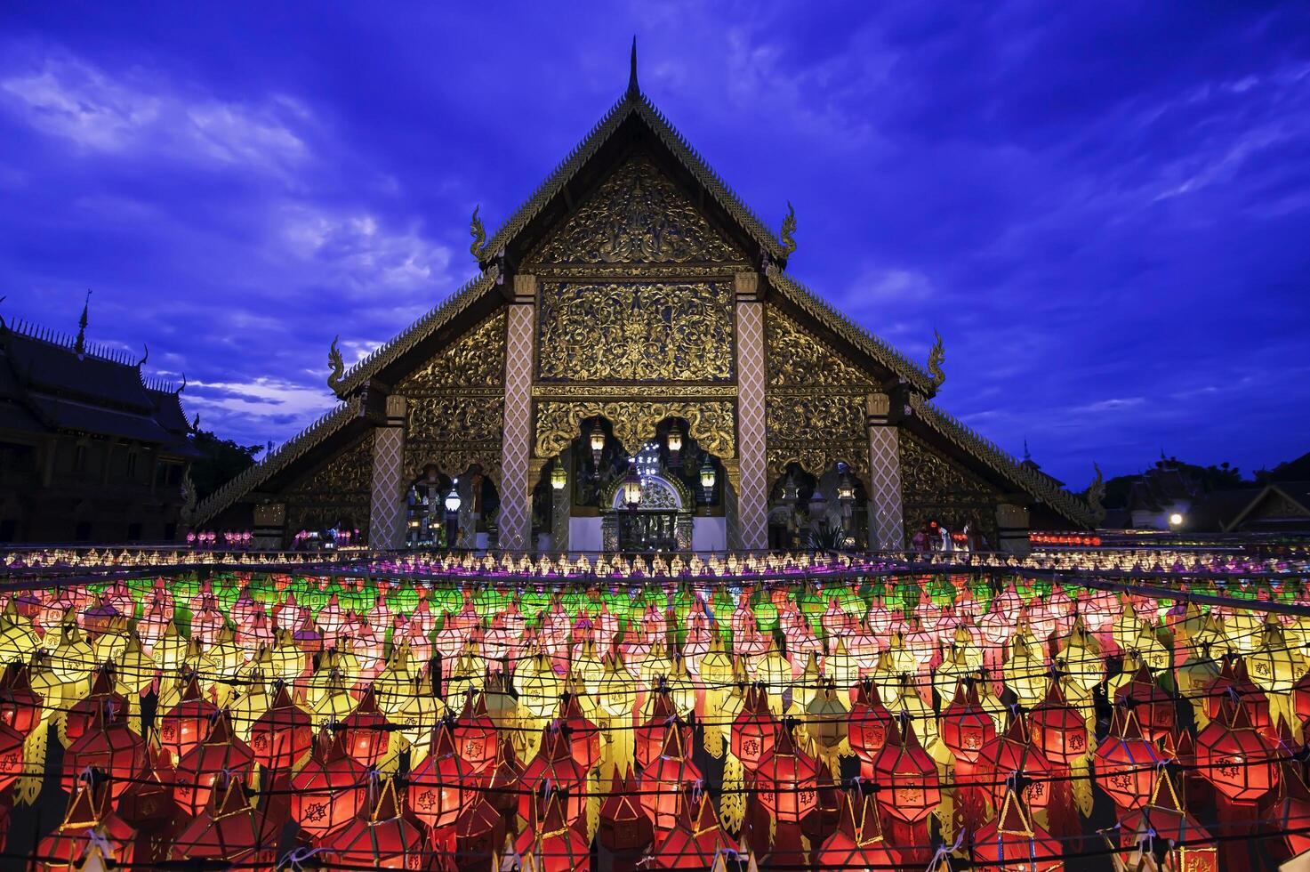 Lanterns made of colorful paper are hung during the annual festival at Wat Phra That Hariphunchai in Lamphun Province. photo