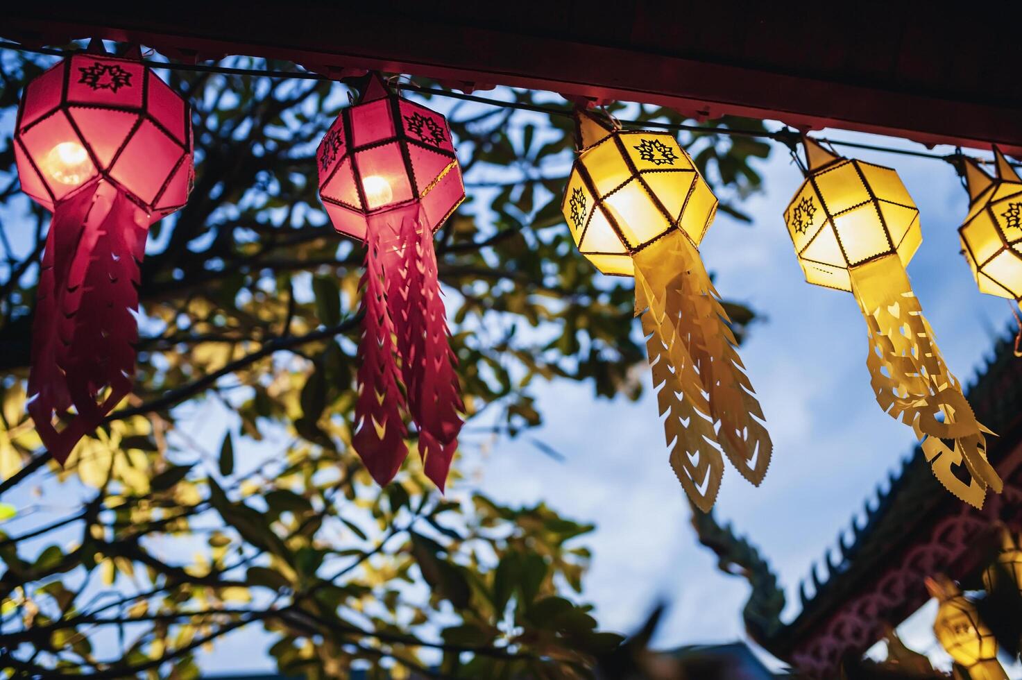 Lanterns made of colorful paper are hung during the annual festival at Wat Phra That Hariphunchai in Lamphun Province. photo