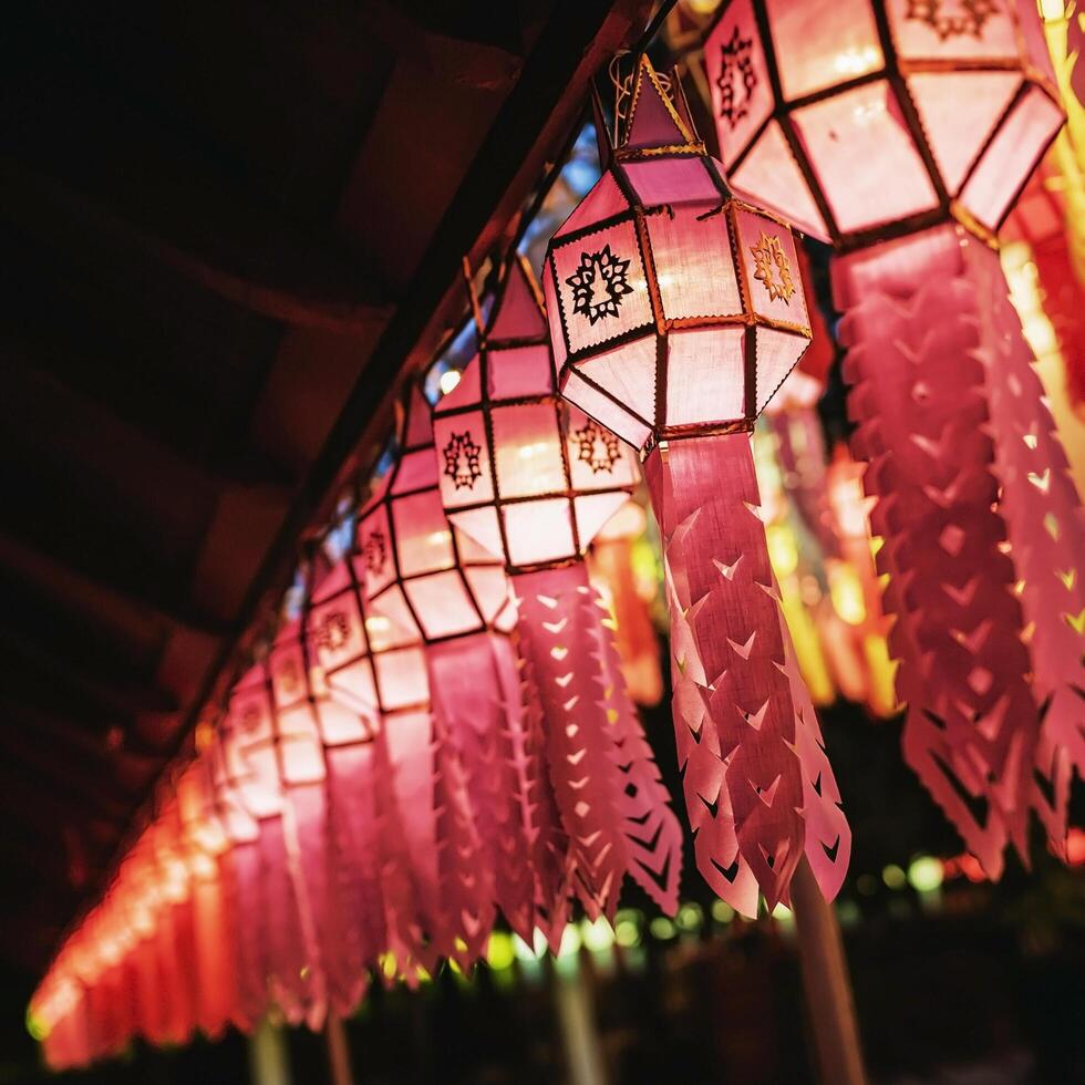 Lanterns made of colorful paper are hung during the annual festival at Wat Phra That Hariphunchai in Lamphun Province. photo