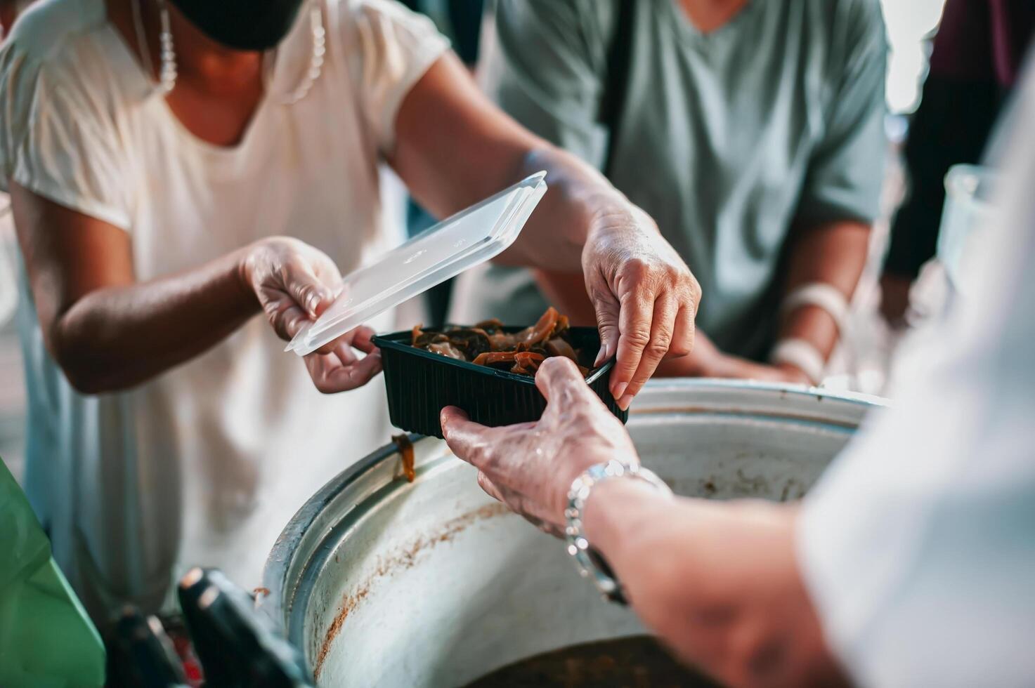 Feeding the poor to hands of a beggar. Poverty concept photo