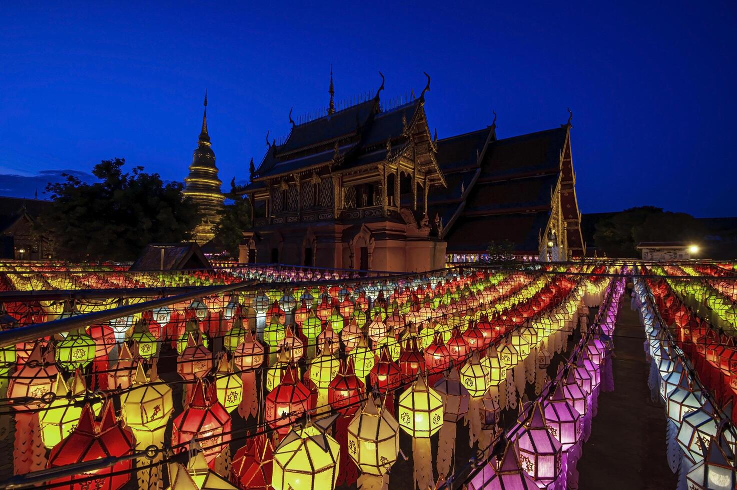 Lanterns made of colorful paper are hung during the annual festival at Wat Phra That Hariphunchai in Lamphun Province. photo