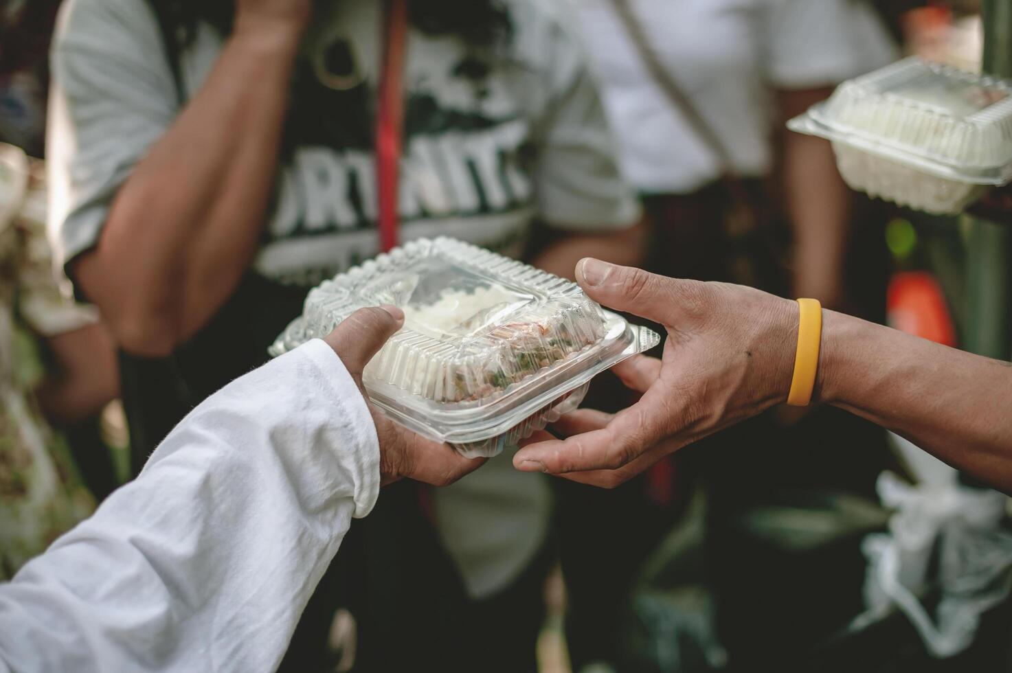 Volunteers are helping to give free food to the hungry homeless. food service and food donation concept photo