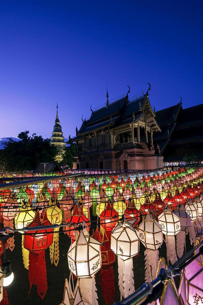 Lanterns made of colorful paper are hung during the annual festival at Wat Phra That Hariphunchai in Lamphun Province. photo