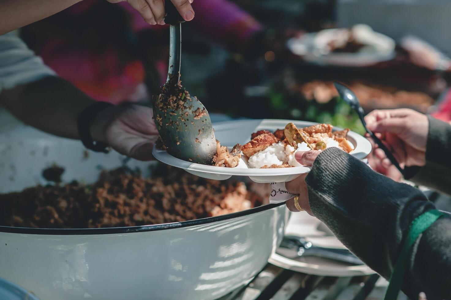 Food donations to fight hunger by sharing free food with people photo