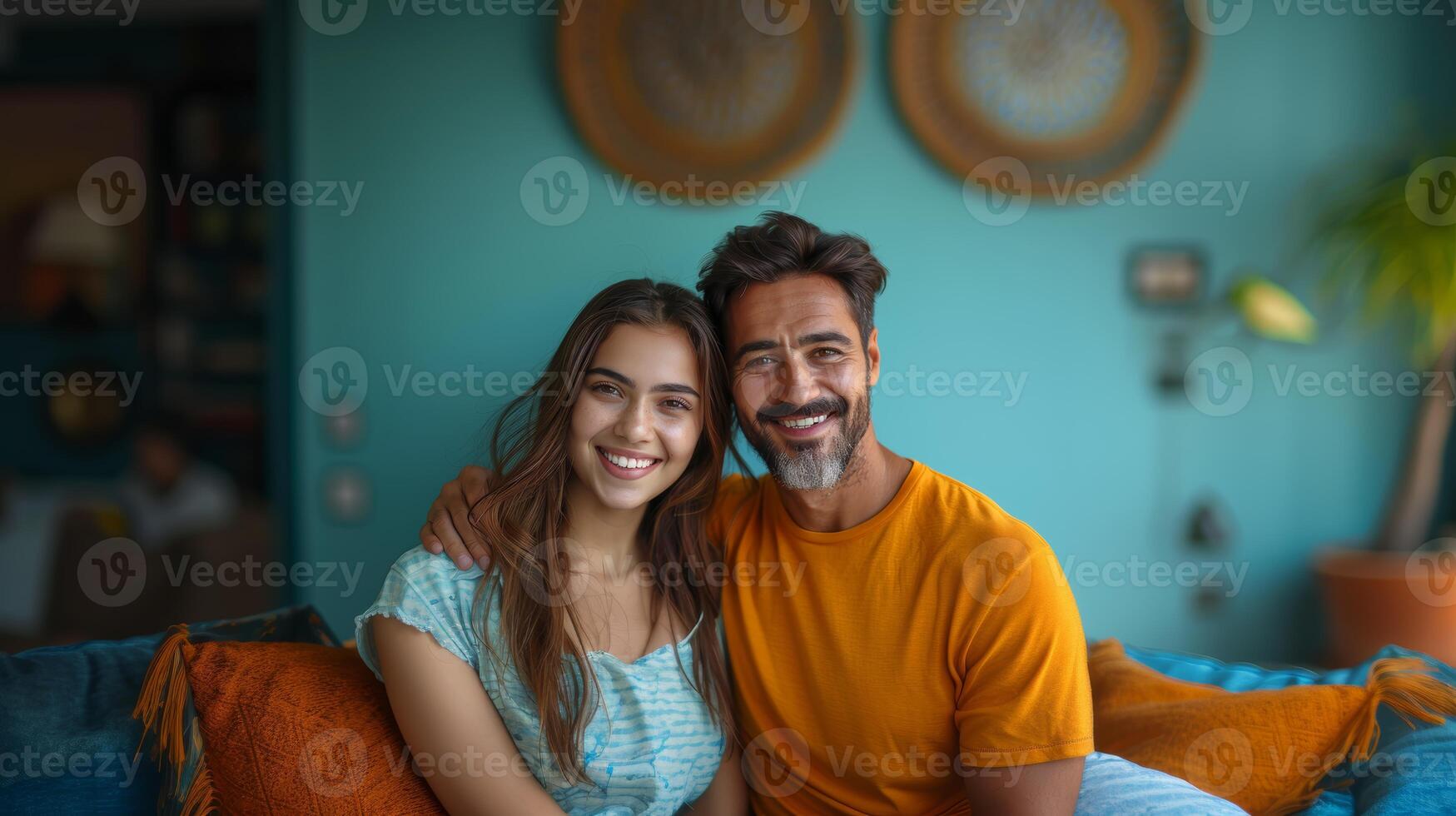 Handsome Young Man and Beautiful Indian Woman Smiling Together on a Cozy Couch photo