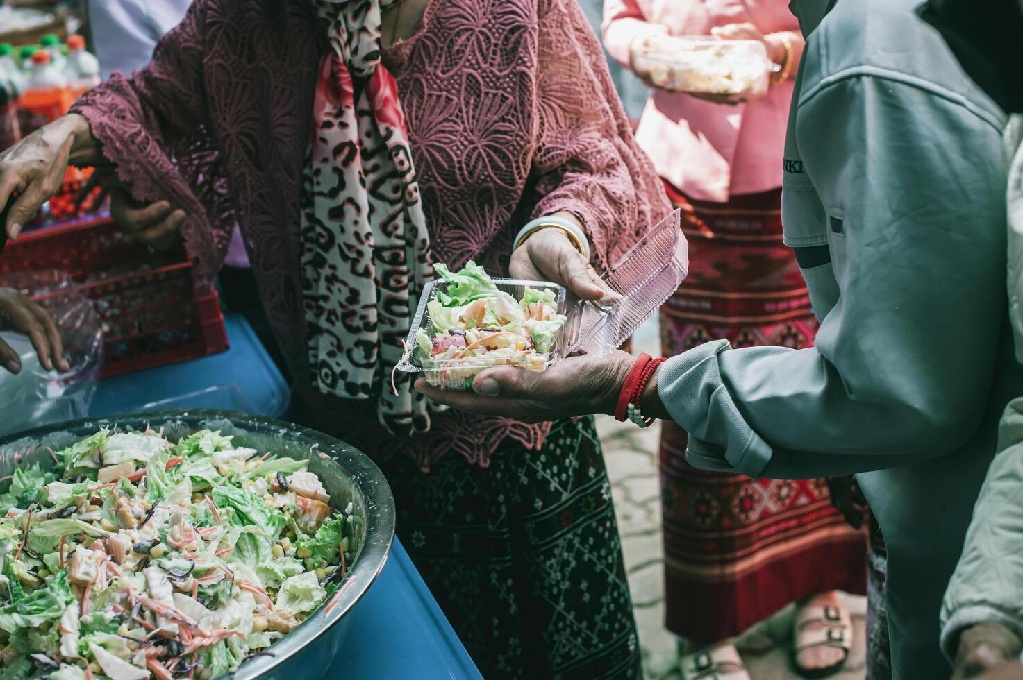 Hands of hungry people asking for free food from volunteers humanitarian aid concept photo