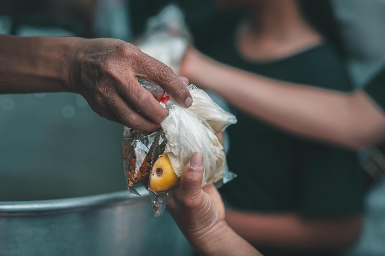 Volunteers serving hot meals to hungry migrants humanitarian aid concept. photo