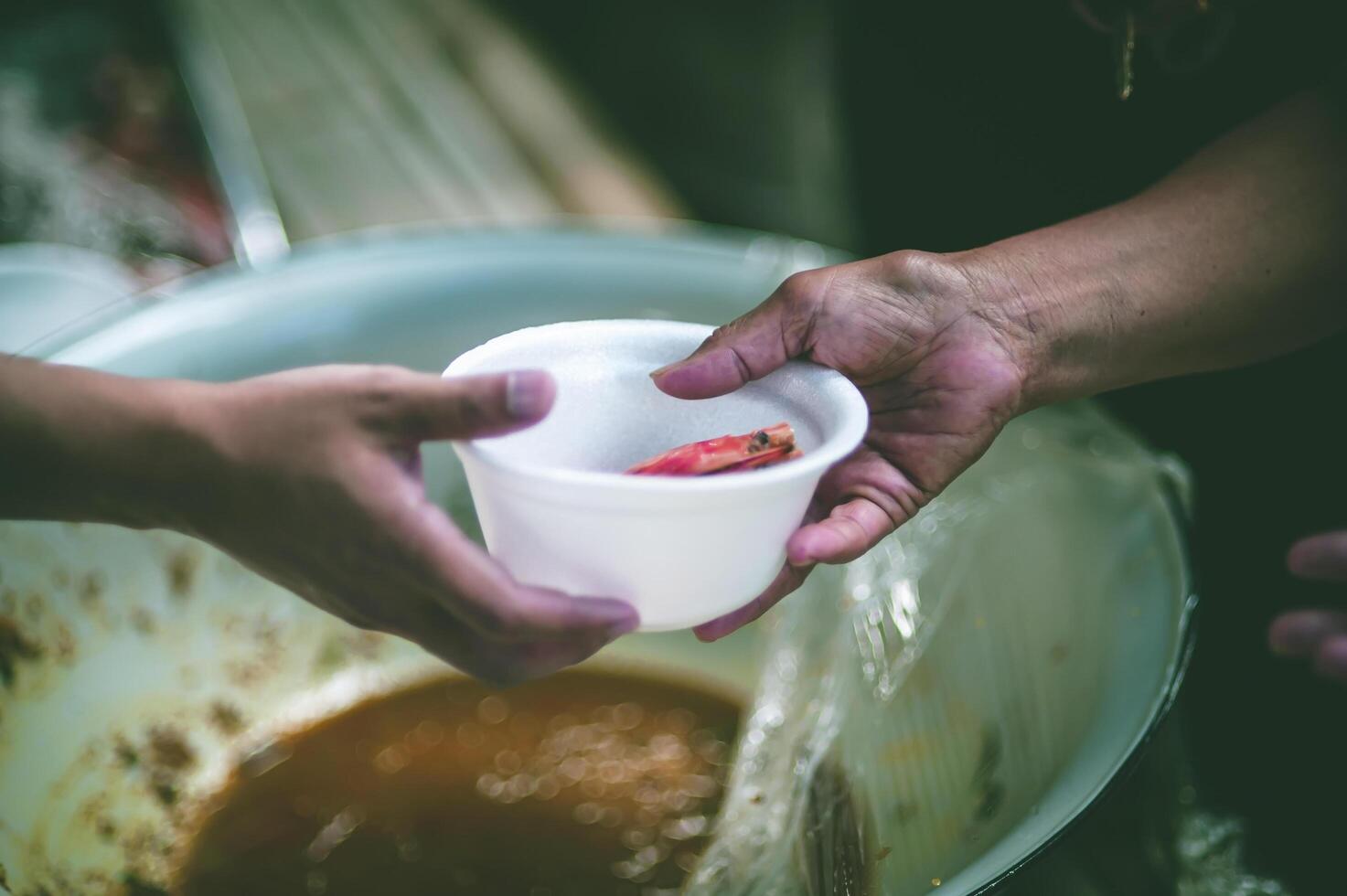 comida asistencia a el Vagabundo pobre desde voluntarios conceptos de público hambre. foto