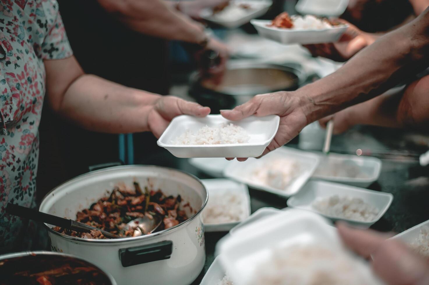 Volunteers offer free food to the poor. the concept of food sharing. photo