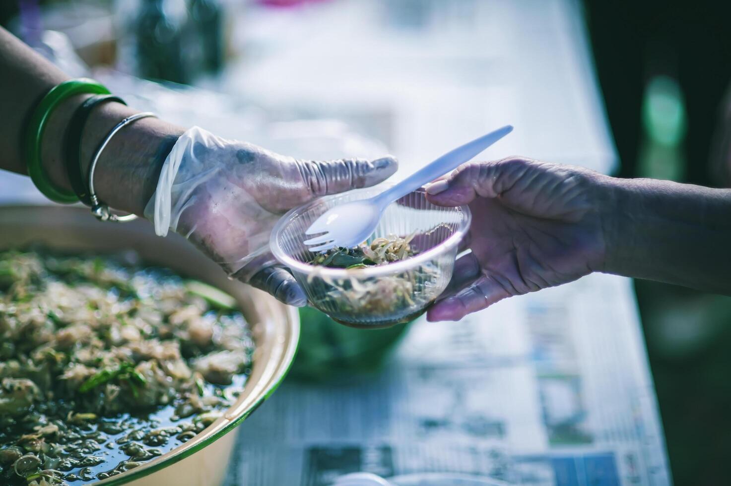 Volunteers are giving free food to help the hungry poor concept of food sharing photo