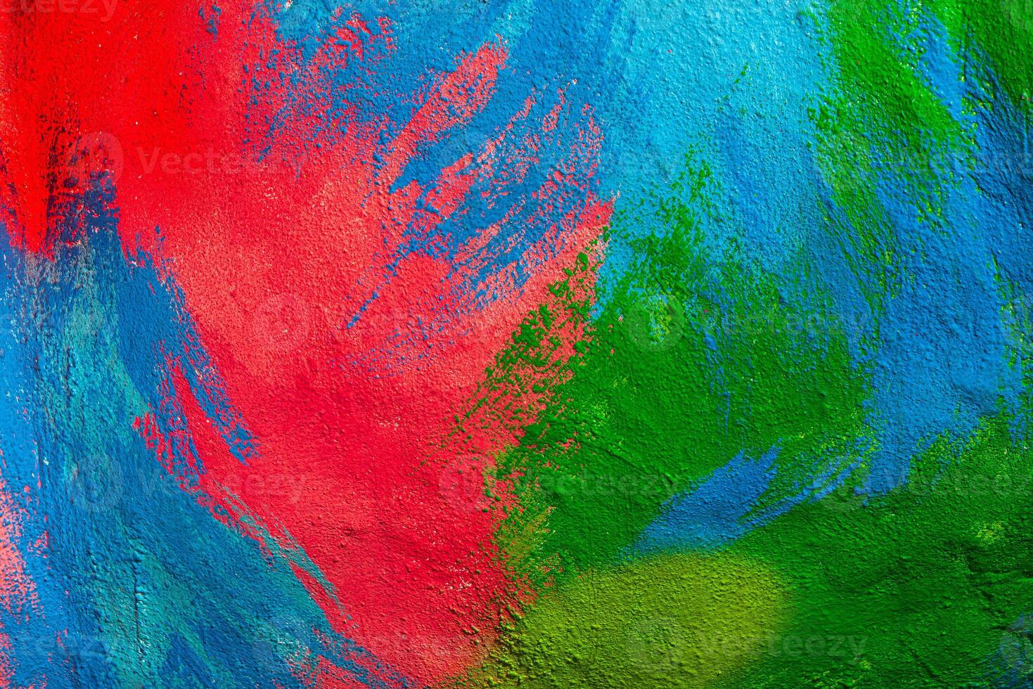 A fragment of colorful graffiti painted on a wall. Abstract urban background. Spray painting art. photo