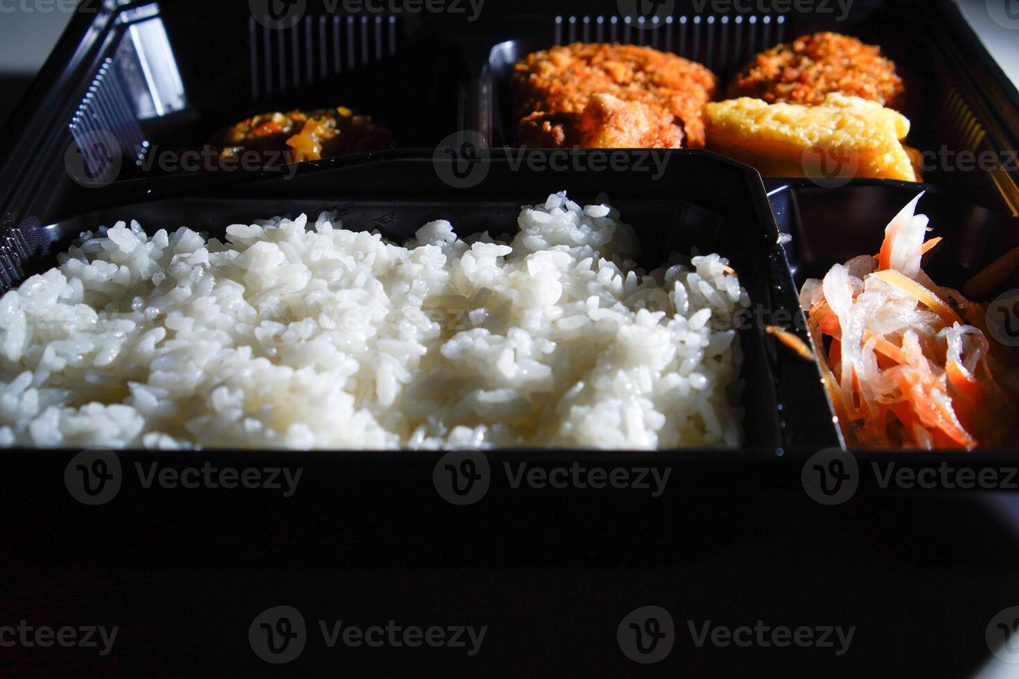 close up of the boxed food on the table. photo