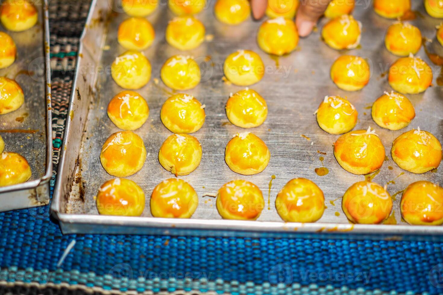 Close-up view of pineapple cakes arranged neatly in a baking pan. photo