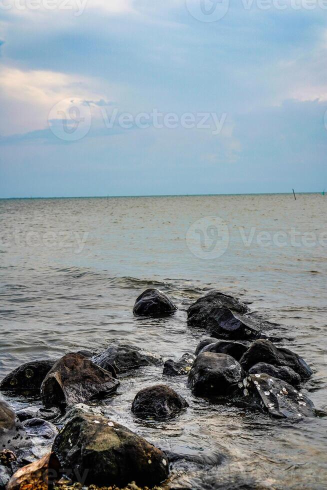 rocks on the edge of the sea to break the waves. photo