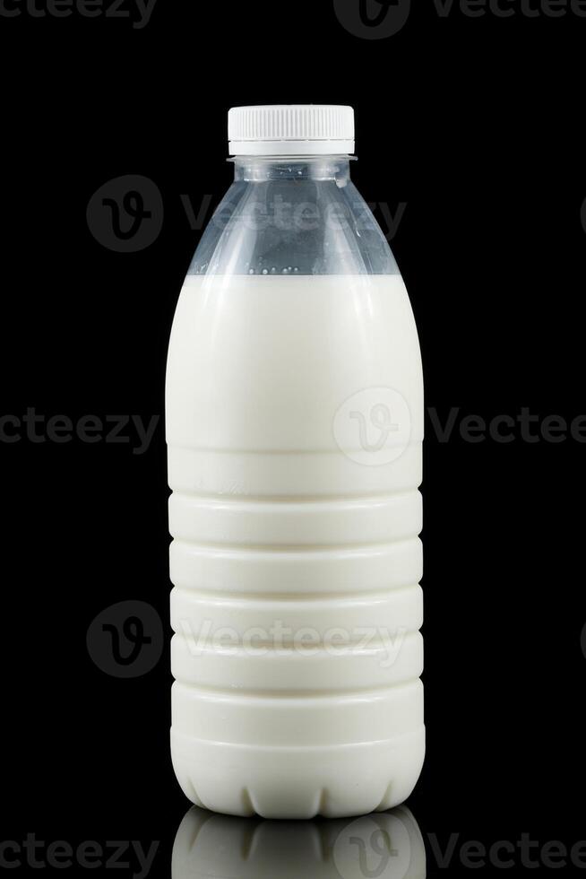 A bottle of milk on a black background photo