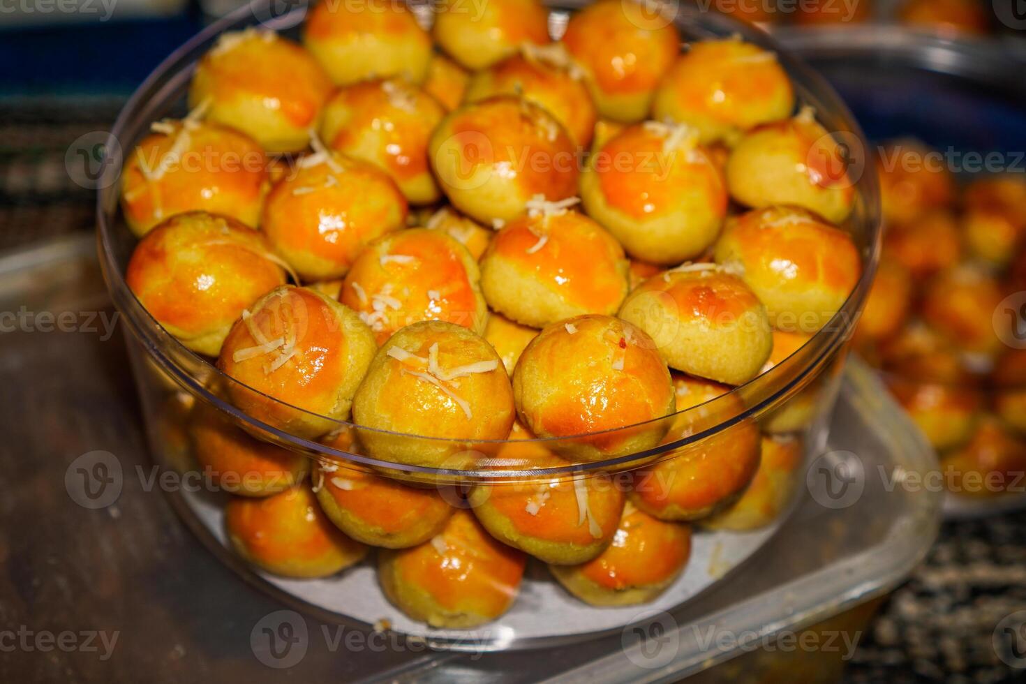 Close-up view of pineapple cake in a transparent jar on the table. photo