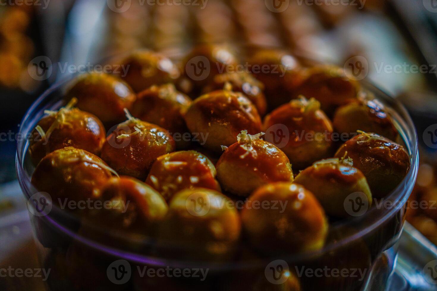 Close-up view of pineapple cake in a transparent jar on the table. photo