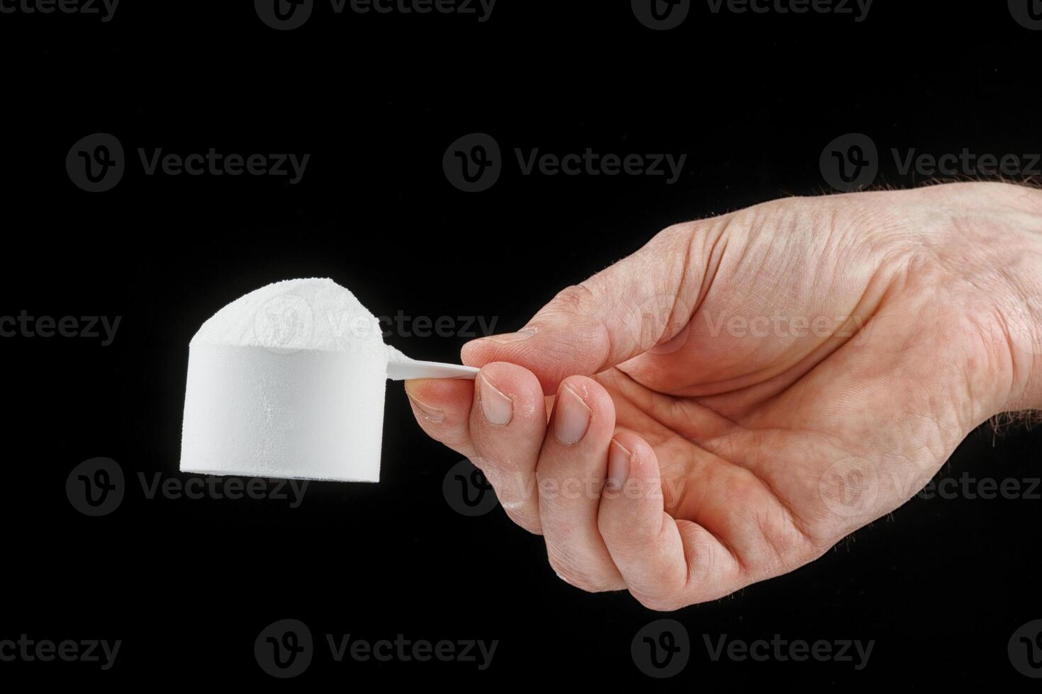 Scoop with protein in hand photo