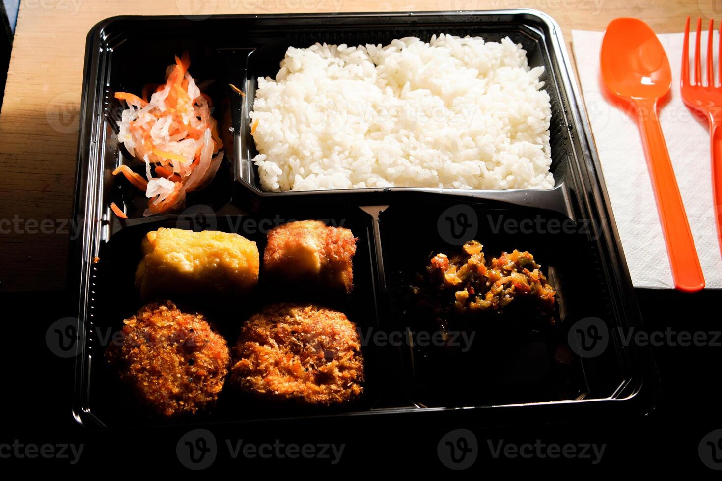 close up of the boxed food on the table. photo