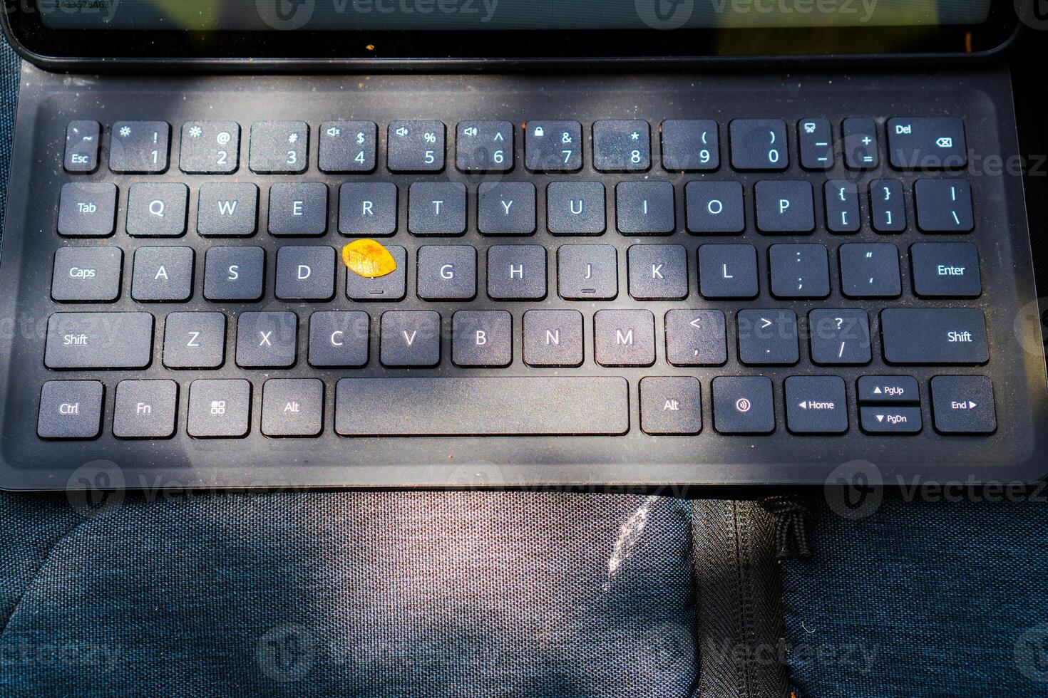 Close-up view of a keyboard for a tablet on a table, in an open room. photo