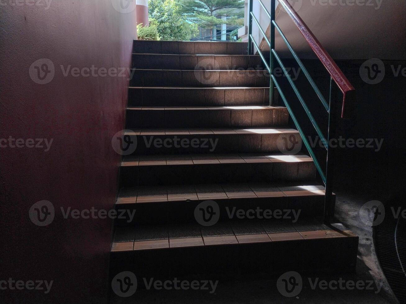 stairs leading upwards with sunlight effect, seen close to the point of view from below. photo