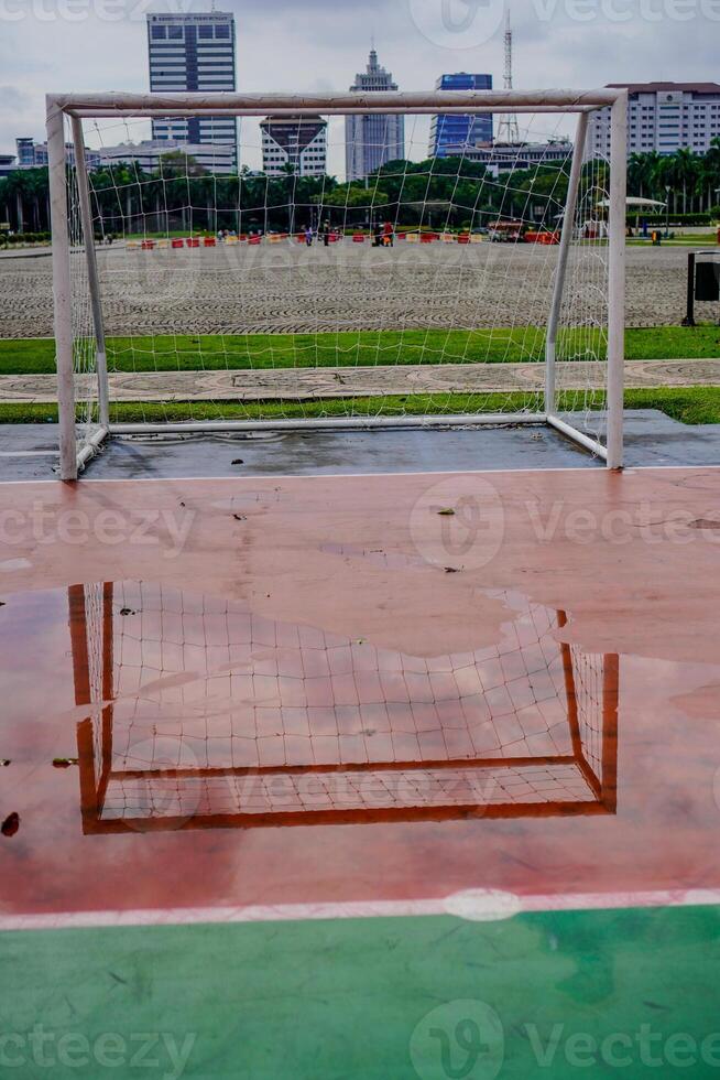 puddles of water on the futsal field goal after rain. photo