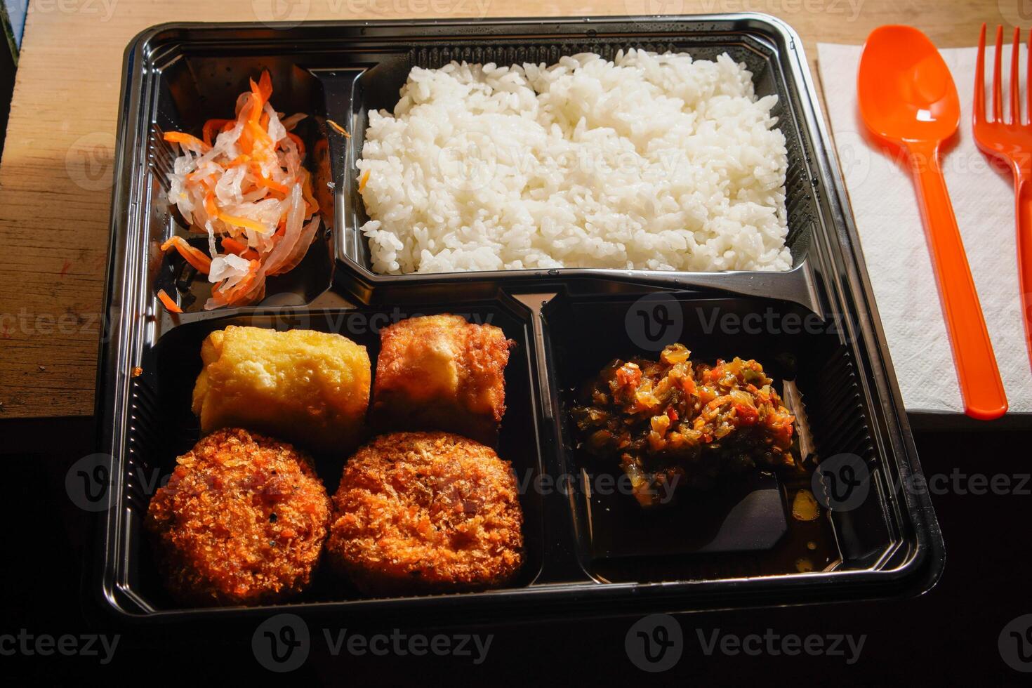 close up of the boxed food on the table. photo
