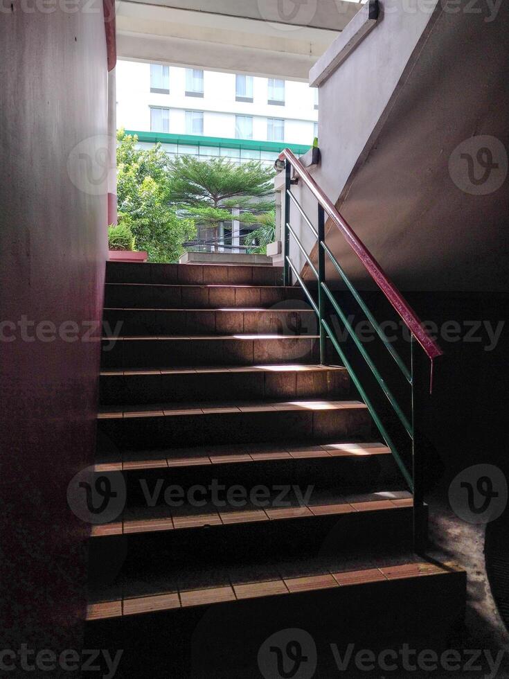 stairs leading upwards with sunlight effect, seen close to the point of view from below. photo