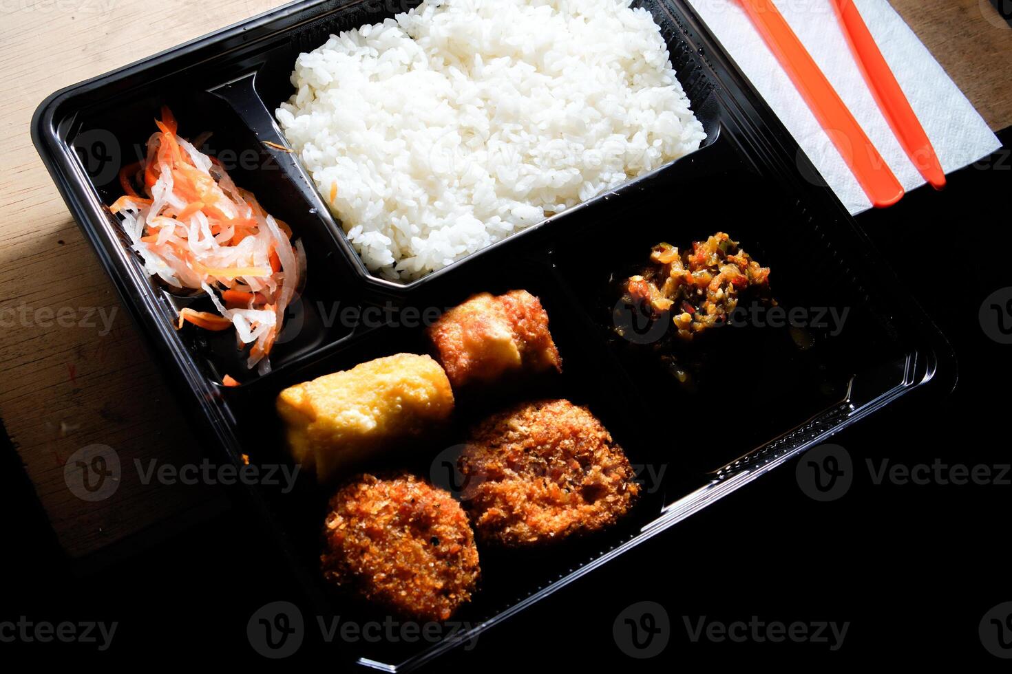 close up of the boxed food on the table. photo