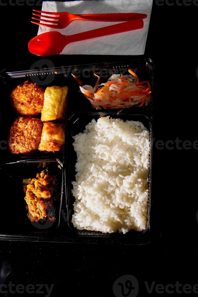 close up of the boxed food on the table. photo