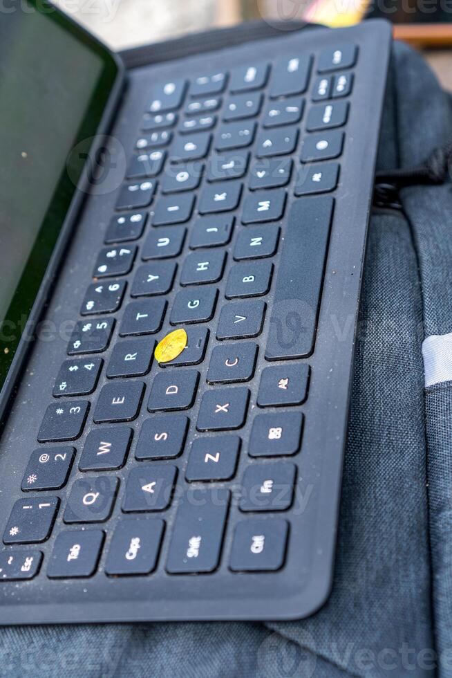 Close-up view of a keyboard for a tablet on a table, in an open room. photo