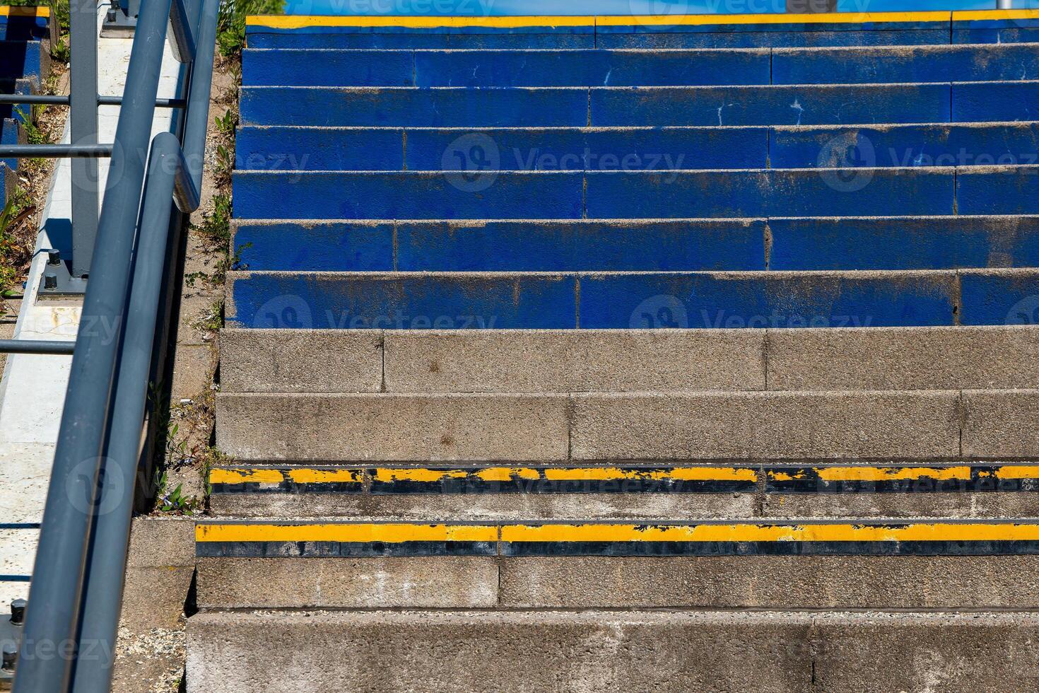 different colored staircase in the city with railing photo