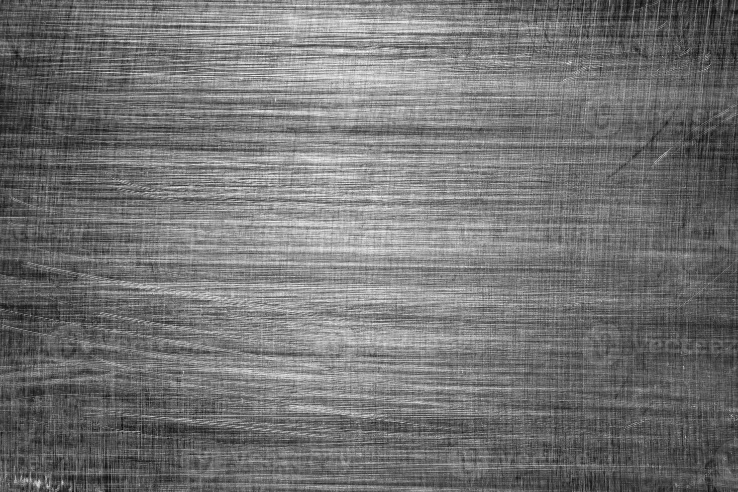 Monochrome texture of shiny scratched metal. Abstract background. photo