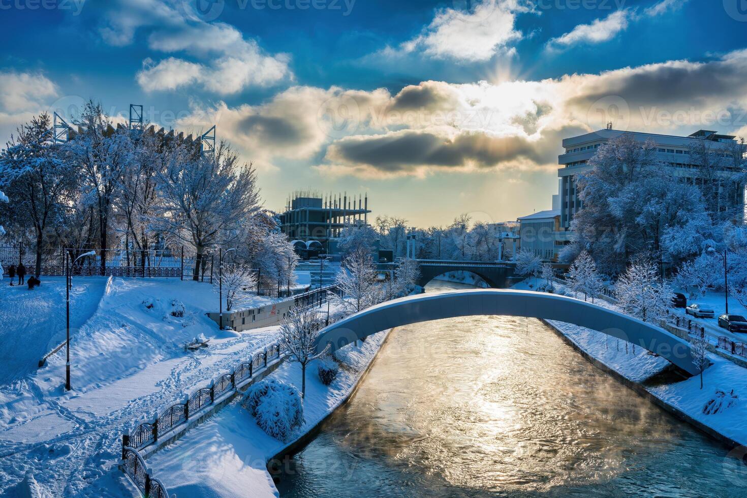 Sunset or dawn on a canal with non-freezing water on a cold winter day. photo