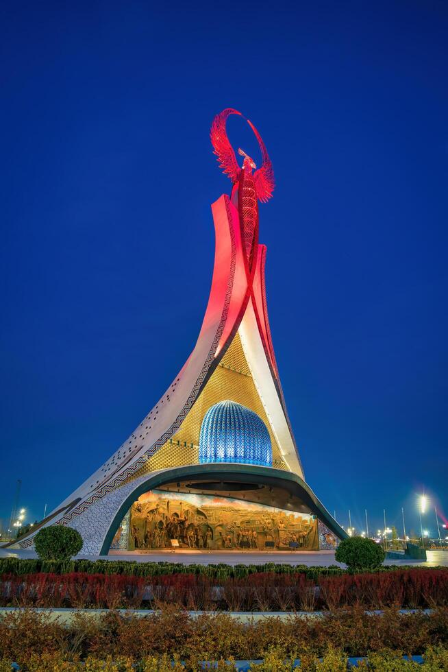 UZBEKISTAN, TASHKENT JANUARY 4, 2023 Illuminated monument of independence in the form of a stele with a Humo bird in the New Uzbekistan park at night. photo