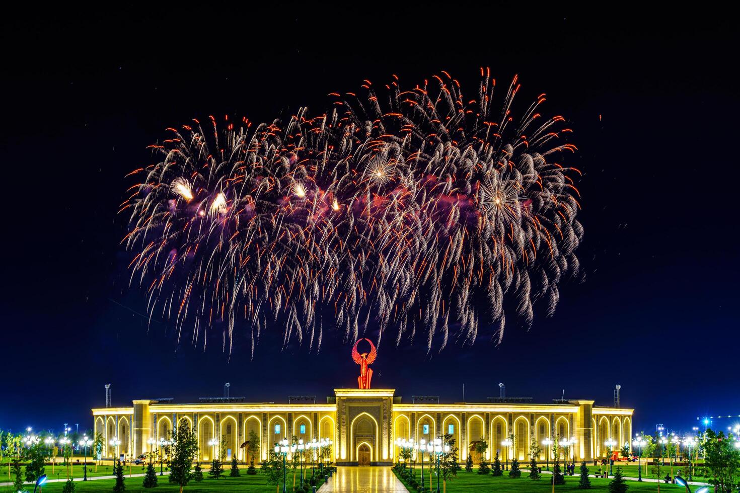 Uzbekistan, Tashkent - September 1, 2023 Multi-colored fireworks over the Independence Monument in Yangi Uzbekistan Park in Tashkent on Independence Day. photo