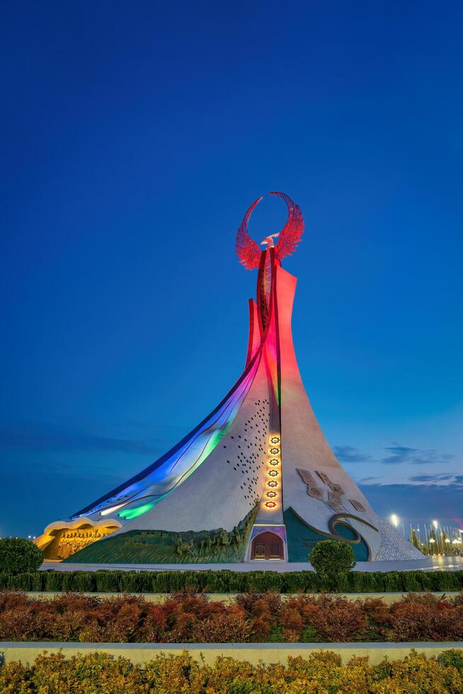UZBEKISTAN, TASHKENT JANUARY 4, 2023 Illuminated monument of independence in the form of a stele with a Humo bird in the New Uzbekistan park at night. photo
