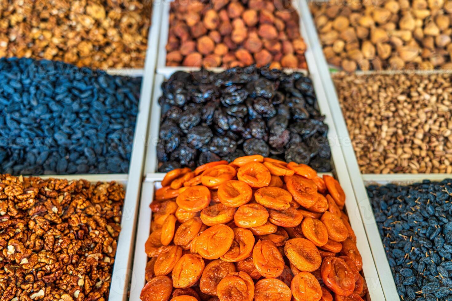 Oriental dried fruits and nuts on the counter of the bazaar. photo