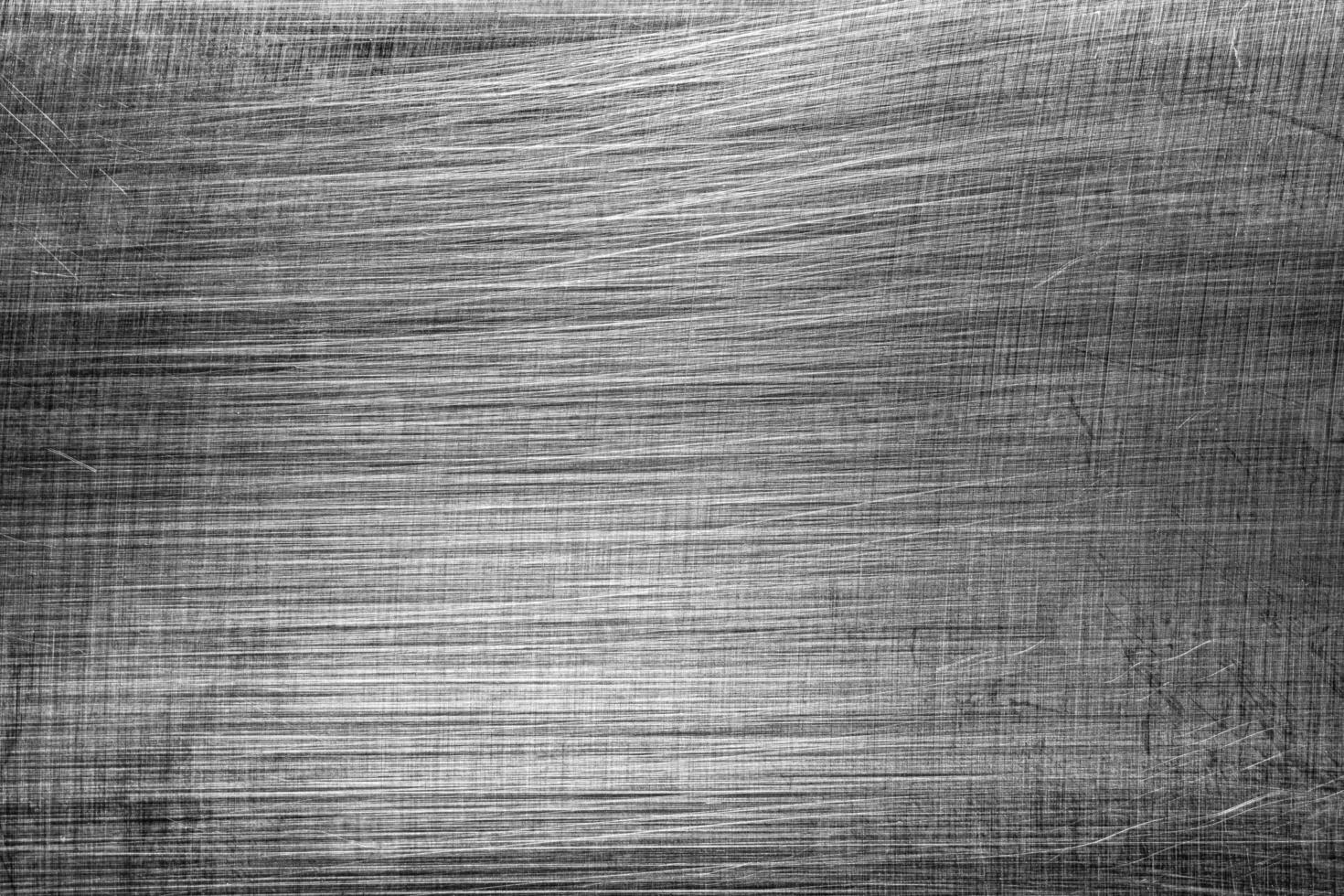 Monochrome texture of shiny scratched metal. Abstract background. photo