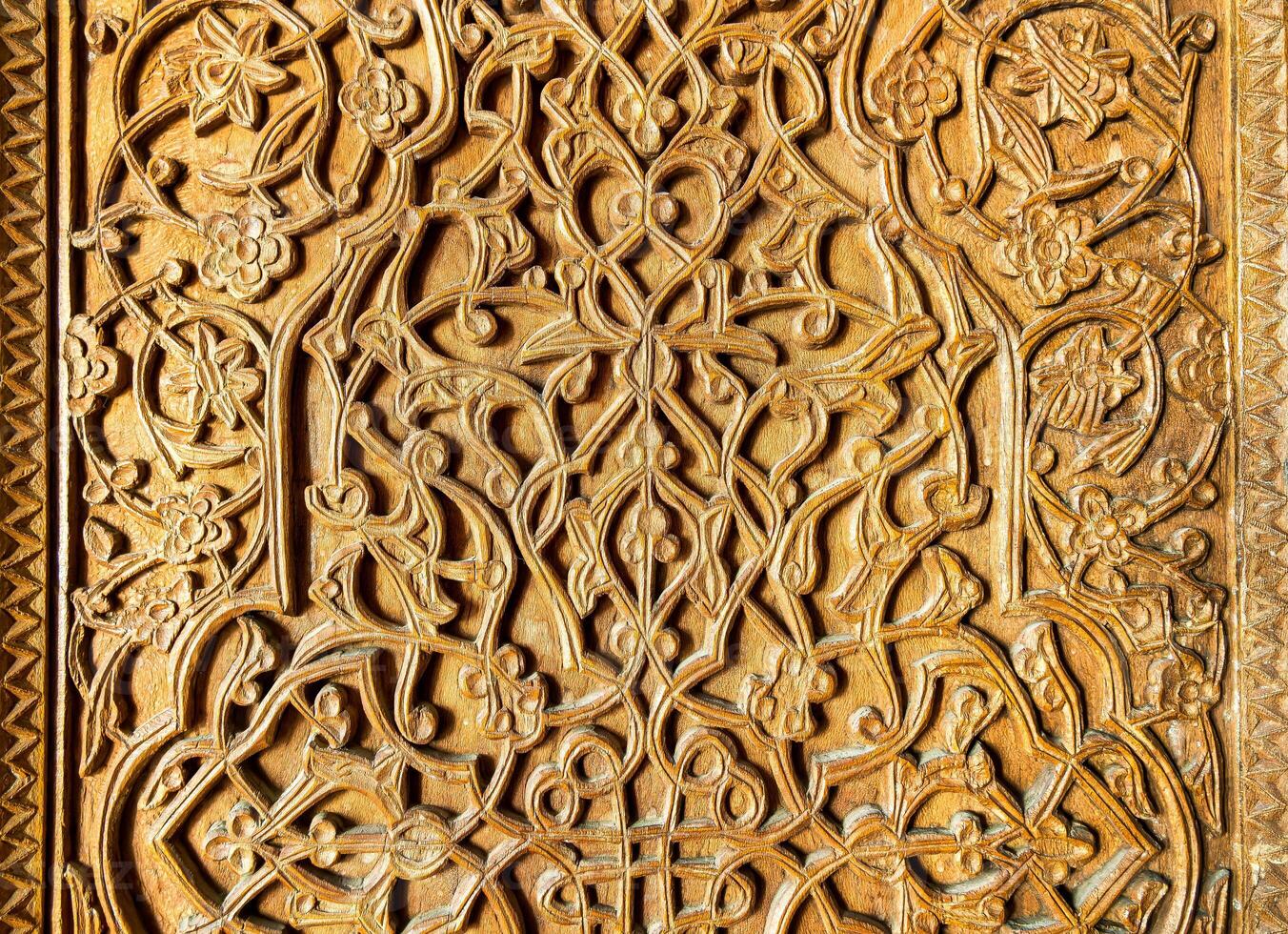 Fragment of an ancient carved wooden door. Ornate. photo