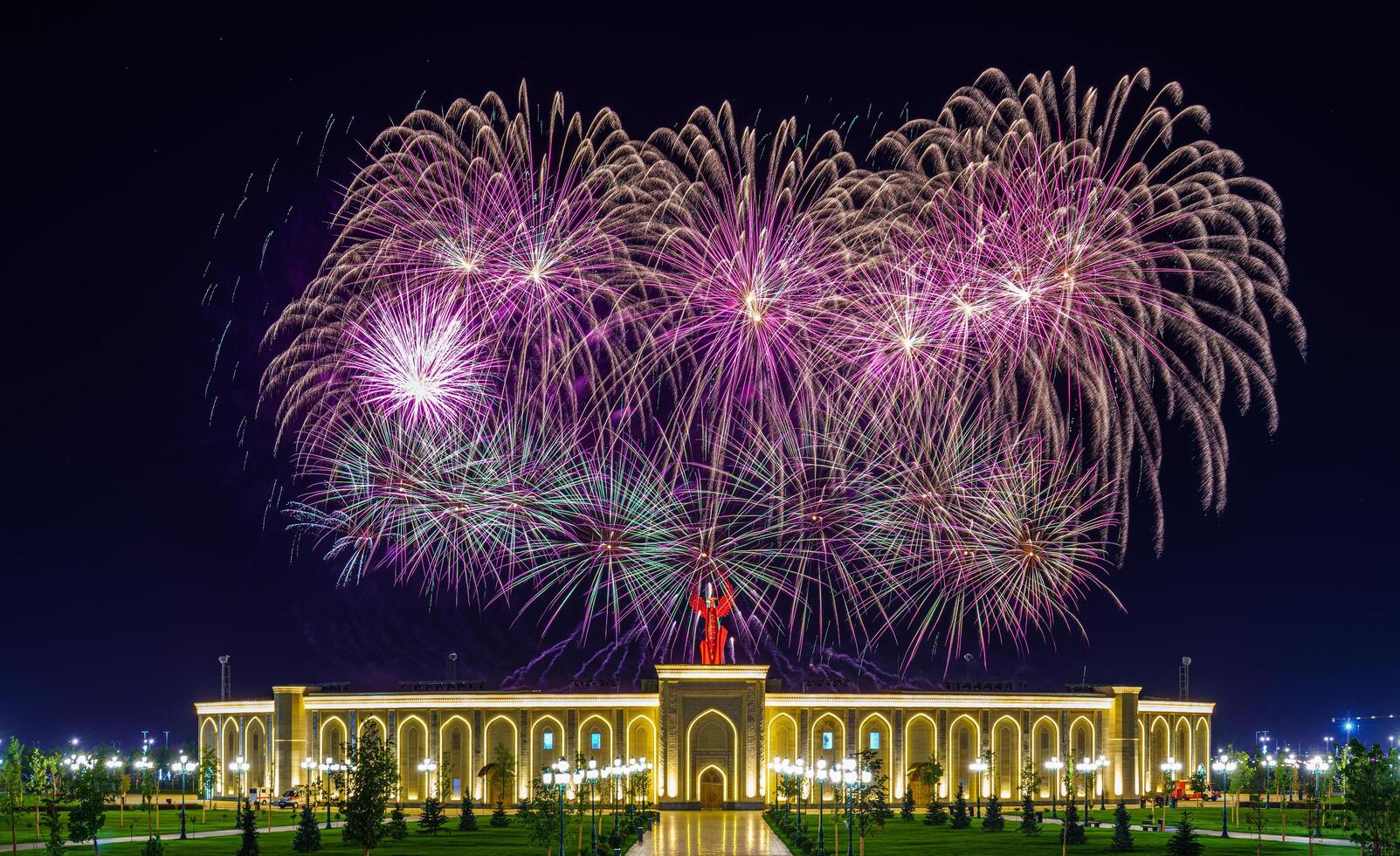 Uzbekistan, Tashkent - September 1, 2023 Multi-colored fireworks over the Independence Monument in Yangi Uzbekistan Park in Tashkent on Independence Day. photo