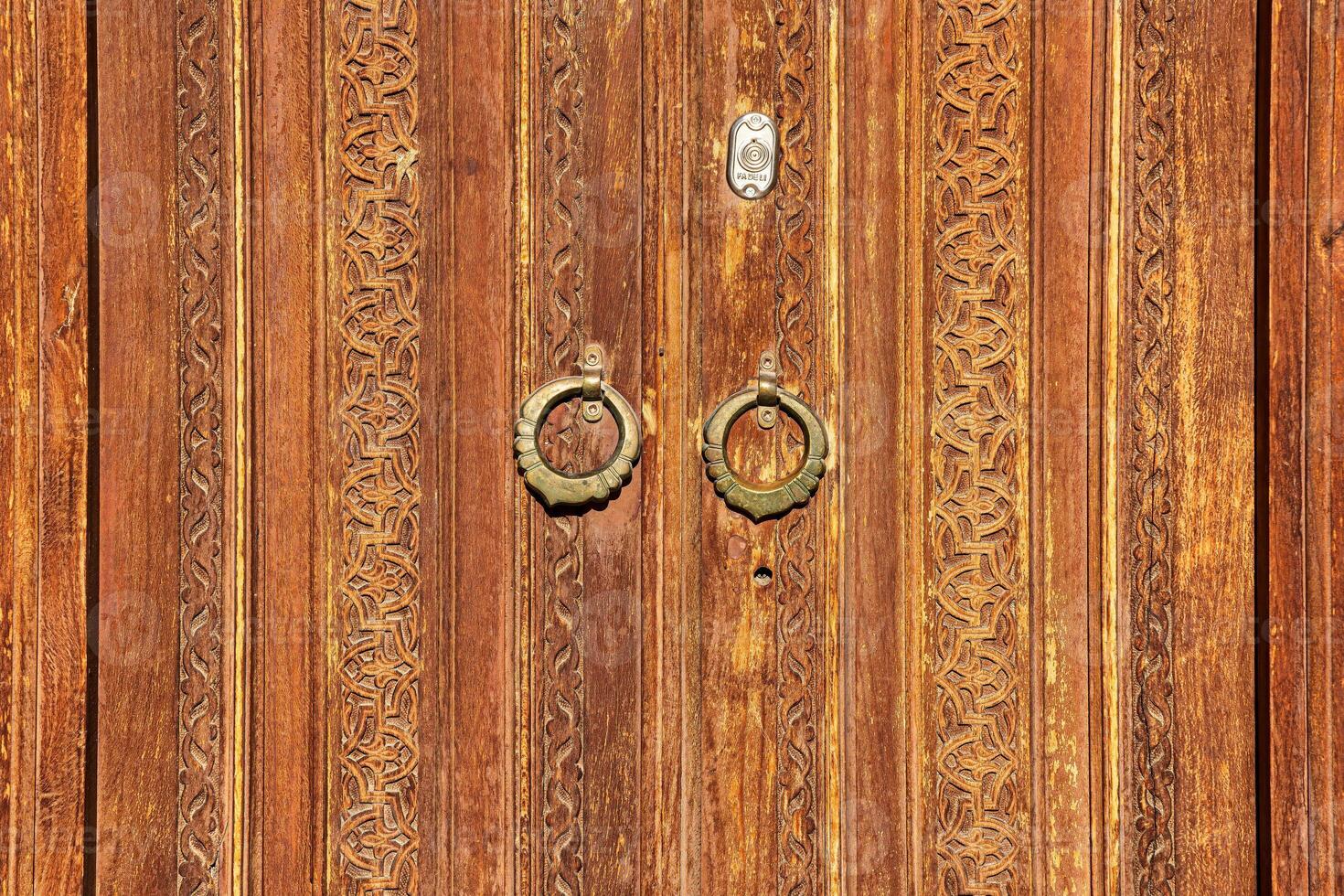 Carved wooden doors with patterns and mosaics. photo