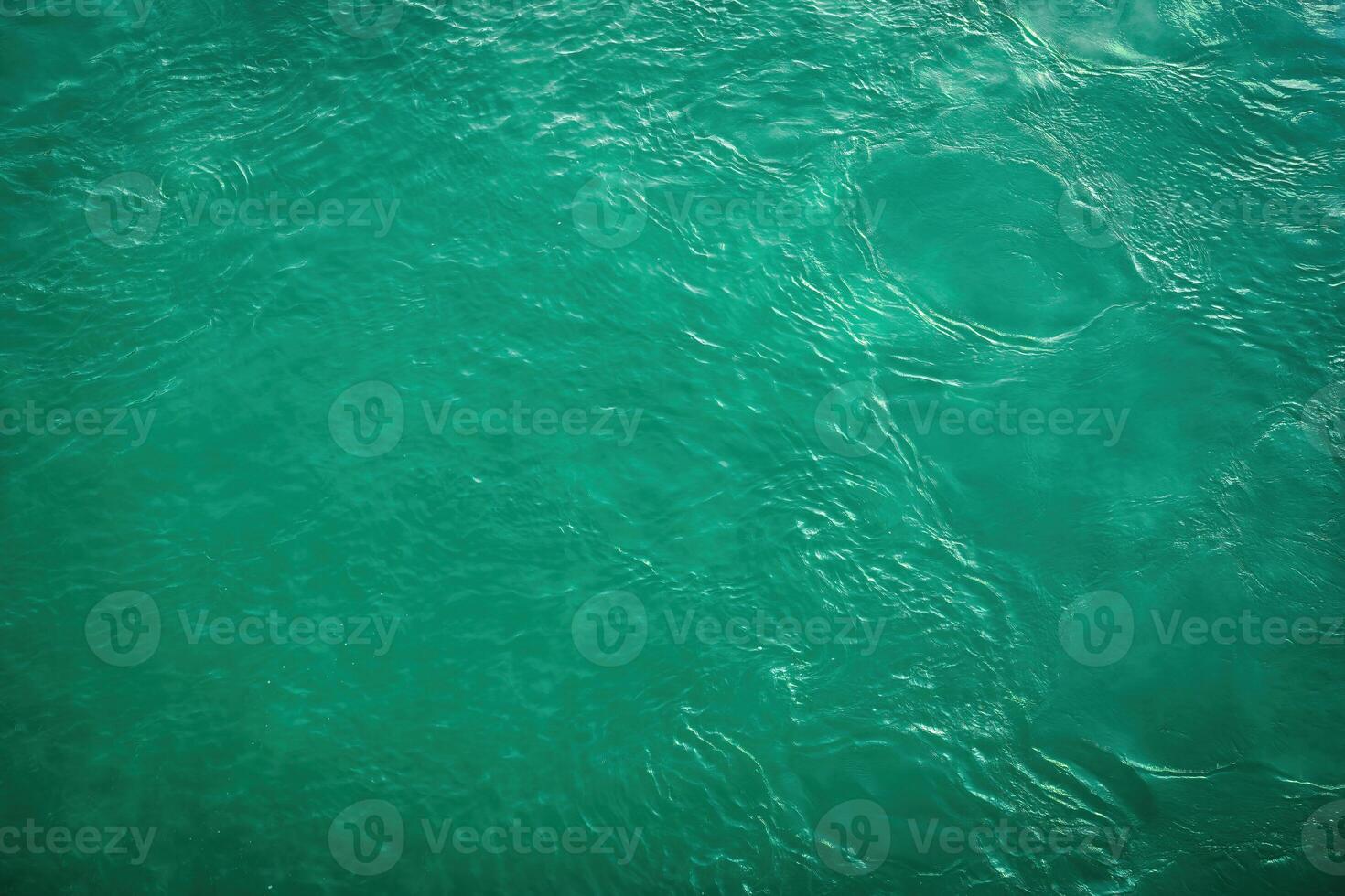 The texture of the waves of turquoise color of fast-flowing water in the river. photo