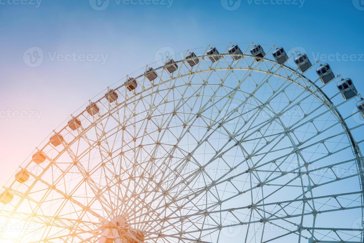 Ferris wheel at sunset or sunrise in an amusement park. photo